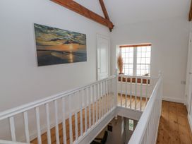 A hallway with a painting and a window at Rock House in Narberth
