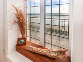 A living room with a window showing the sea at Rock House in Narberth