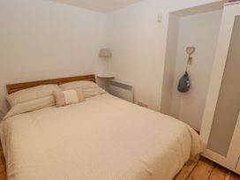 A bedroom with a bed and nightstand at Rock House in Narberth