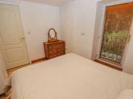 A bedroom with a bed and a dressing table at Rock House in Narberth