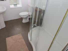 A bathroom with a sink, toilet, and shower at Rock House in Narberth