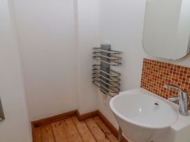 A bathroom with a wash basin and heated towel rail at Rock House in Narberth
