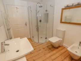 A bathroom with shower, toilet, sink, and bidet at Rock House in Narberth