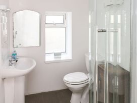 A bathroom with a sink, toilet, and shower at Rock House in Narberth