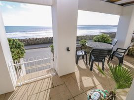 An outdoor area with table and chairs overlooking the sea at Rock House Narberth