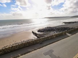 A beach with sand and waves at Rock House in Narberth