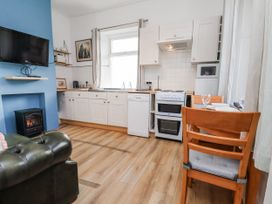 A kitchen with appliances and furniture at Hornblower Lodge in Whitby