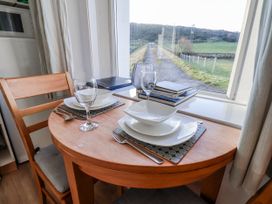 A dining table set with plates and glasses at Hornblower Lodge in Whitby