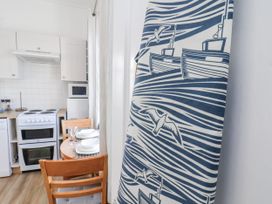 A kitchen with a dining table and chairs at Hornblower Lodge in Whitby