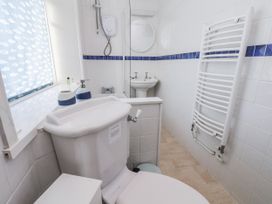 A bathroom featuring a toilet, sink, and shower at Hornblower Lodge in Whitby