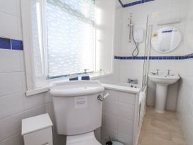 A bathroom with a toilet, sink, and shower at Hornblower Lodge in Whitby