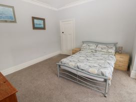 A bedroom with a bed and side table at Kenvor, Newport, Pembrokeshire