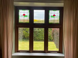 A window with stained glass and garden view at Kenvor Newport, Pembrokeshire