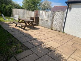 A garden with a table and chairs at Kenvor, Newport, Pembrokeshire