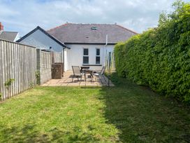 A garden with patio furniture and fence at Kenvor Newport, Pembrokeshire