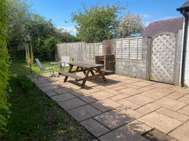 A garden with a patio table and chairs at Kenvor in Newport, Pembrokeshire