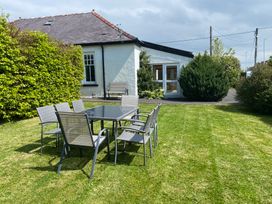 A table and chairs on grass in an outdoor area at Kenvor, Newport, Pembrokeshire
