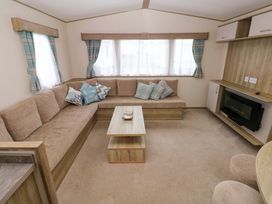 A living room with a sofa and coffee table at 82 Manorbier Park in Manorbier