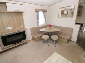 A dining area with a table and chairs at 82 Manorbier Park, Manorbier
