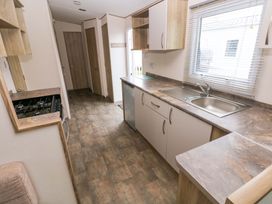 A kitchen with a sink and gas stove at 82 Manorbier Park in Manorbier