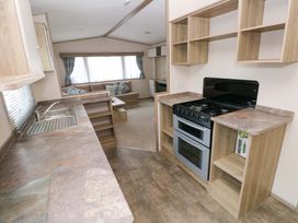 A kitchen with a sink and oven at 82 Manorbier Park in Manorbier