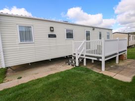 A caravan with steps and a railing at 82 Manorbier Park in Manorbier