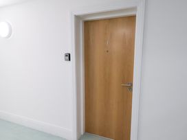 A wooden door with a number at One Union Mill - garden apartment in Whitby
