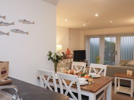 A dining area with a table and chairs at One Union Mill - garden apartment in Whitby