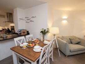 A dining room with a table and chairs at One Union Mill - garden apartment Whitby