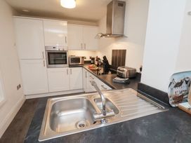 A kitchen with appliances including an oven and microwave at One Union Mill - garden apartment Whitby