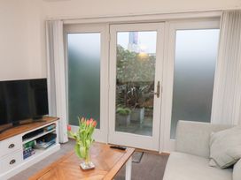 A living room with a television and a coffee table at One Union Mill - garden apartment in Whitby