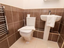 A bathroom with a toilet and sink at One Union Mill - garden apartment in Whitby