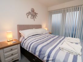 A bedroom with a bed and bedside table at One Union Mill - garden apartment in Whitby