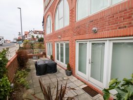 A garden area with paved stones and potted plants at One Union Mill - garden apartment Whitby