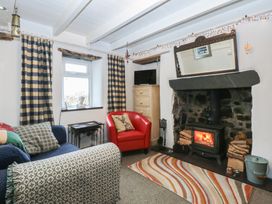 A living room with a fireplace and sofa at Parc y Brenin Holidays, Abersoch