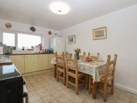 A kitchen with a dining table and chairs at Parc y Brenin Holidays, Abersoch