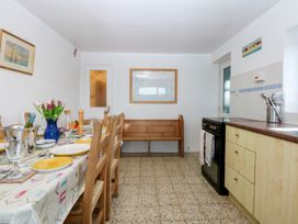 A kitchen with a dining table and chairs at Parc y Brenin Holidays, Abersoch