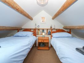 A bedroom with two beds and a nightstand at Parc y Brenin Holidays, Abersoch