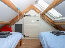 A bedroom with two beds and a door at Parc y Brenin Holidays, Abersoch