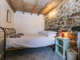 A bedroom with a bed and a nightstand at Parc y Brenin Holidays, Abersoch