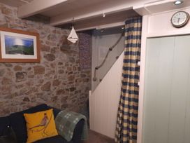 A living room with a sofa and photo frame at Parc y Brenin Holidays, Abersoch