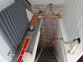 A staircase with skis and a radiator at Parc y Brenin Holidays, Cilan near Abersoch