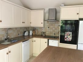 A kitchen with cabinets and appliances at Meadow Lodge in Cerney Wick near South Cerney, Cotswolds