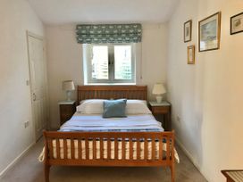 A bedroom with a bed and bedside tables at Meadow Lodge, Cerney Wick near South Cerney, Cotswolds