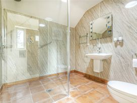 A bathroom with a shower, toilet, and sink at Meadow Lodge in Cerney Wick near South Cerney, Cotswolds