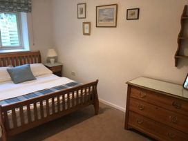 A bedroom with a bed and lamp at Meadow Lodge Cerney Wick near South Cerney, Cotswolds