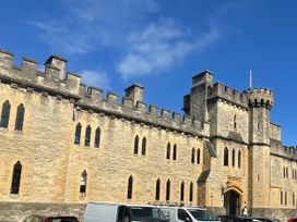 A castle building with towers and windows in the background at Meadow Lodge, Cerney Wick near South Cerney, Cotswolds