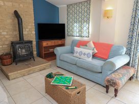 A living room with a sofa and a fireplace at Meadow Lodge Cerney Wick near South Cerney Cotswolds