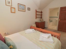A bedroom with a bed and drawer at Meadow Lodge in Cerney Wick near South Cerney, Cotswolds