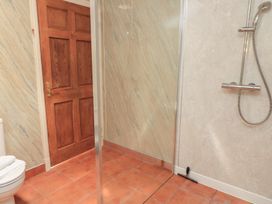 A bathroom with a shower and toilet at Meadow Lodge Cerney Wick near South Cerney, Cotswolds